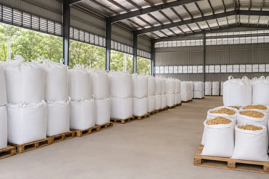 Mùn cưa được kê pallet và bảo quản trong kho khô ráo